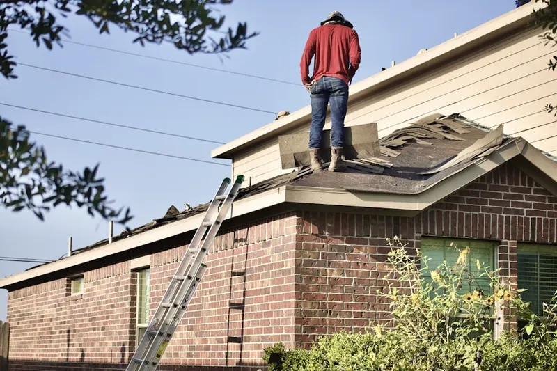 Professional roofer working on a residential roof in Boulevard Upland